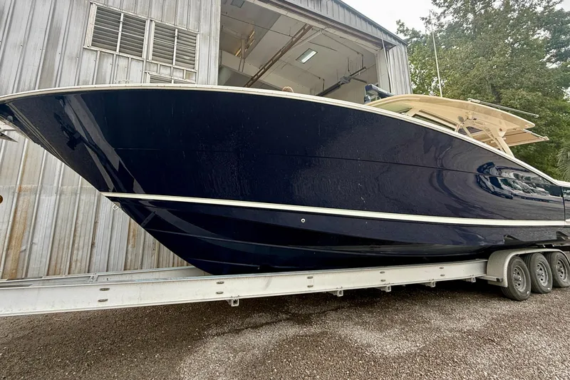 Slide: The Image of 2019 Scout 420 LXF boat with four engines on a calm waterway. - 3