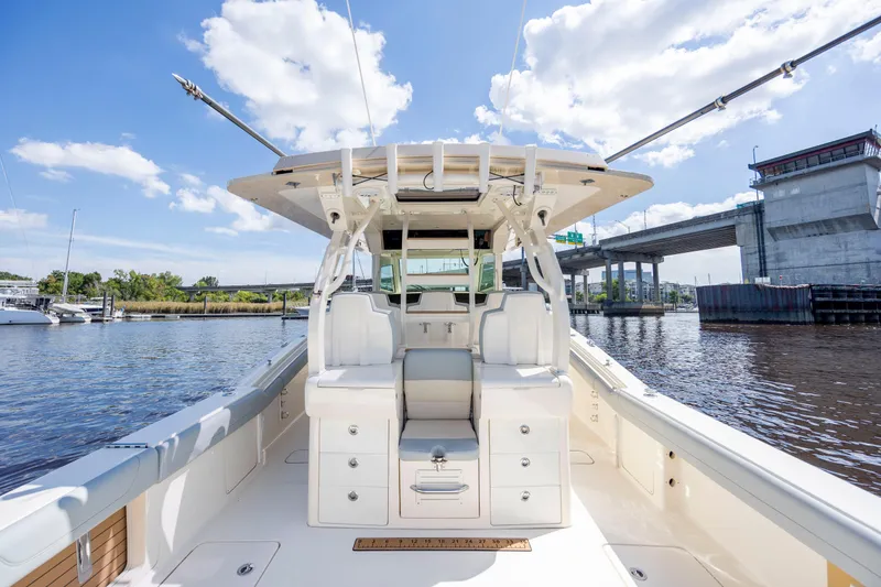 Slide: The Image of Luxurious interior of 2019 Scout 420 LXF boat with seating, TV, and shower area. - 30