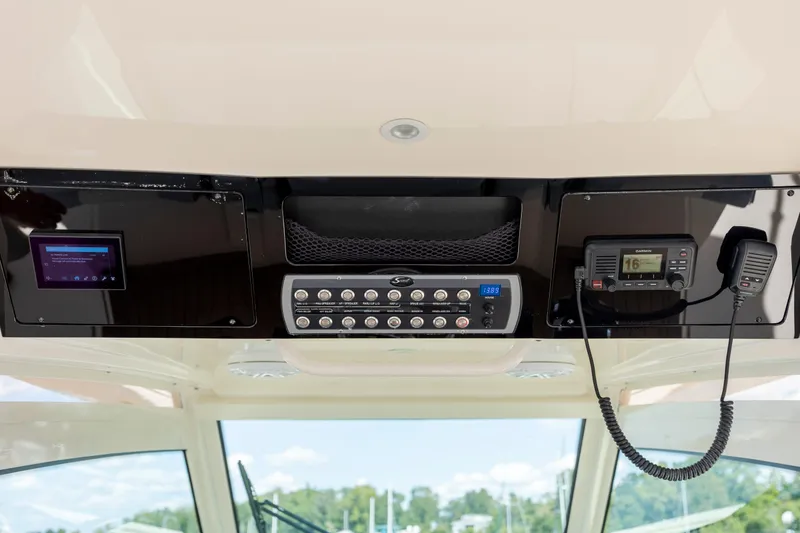 Slide: The Image of 2019 Scout 420 LXF boat dashboard with control panel and communication devices. - 36