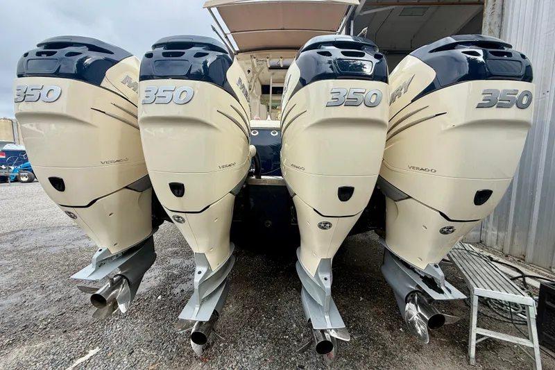 Slide: The Image of 2019 Scout 420 LXF boat cruising on a calm waterway under a blue sky. - 4