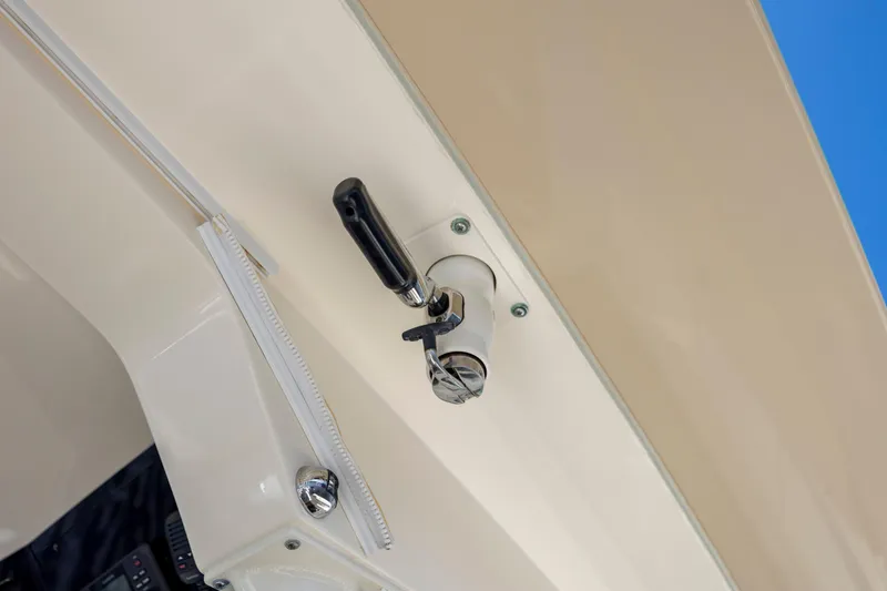 Slide: The Image of 2019 Scout 420 LXF boat interior with open storage compartment, near waterway and bridge. - 40