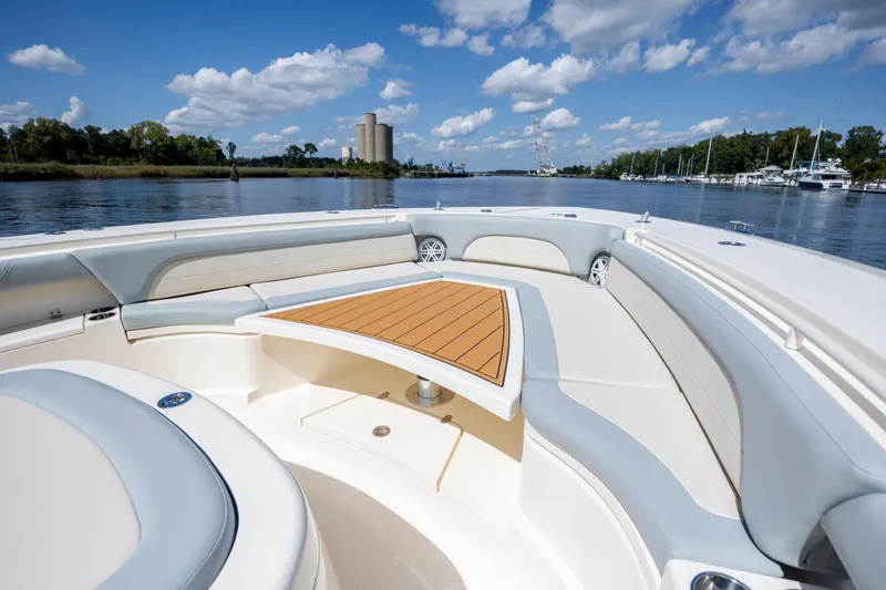 Slide: The Image of 2019 Scout 420 LXF yacht with extended deck on calm water, under a blue sky. - 42