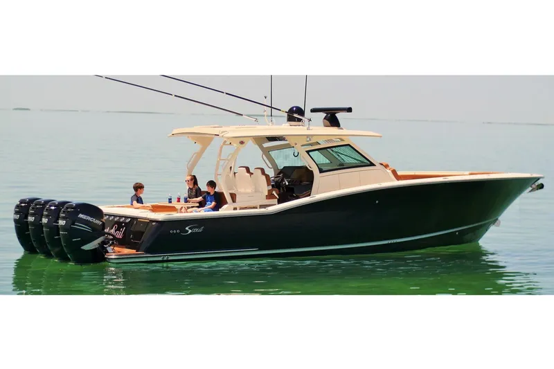 Slide: The Image of 2019 Scout 420 LXF boat with four powerful engines on a calm waterway. - 5