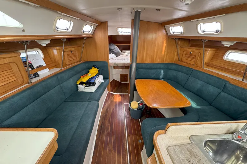 Slide: The Image of Interior of a 1999 Catalina 34 MkII sailboat with cozy seating and wooden table. - 11