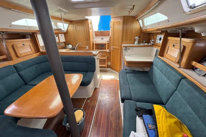 Slide: The Image of Interior of 1999 Catalina 34 MkII sailboat with wood finish and blue seating. - 18