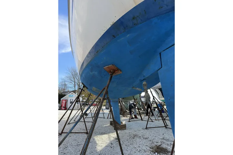 Slide: The Image of 1999 Catalina 34 MkII sailboat on stands, blue hull, outdoor storage. - 25