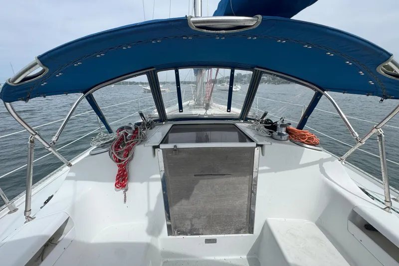 Slide: The Image of 1999 Catalina 34 MkII sailboat cockpit with blue canopy and ropes on deck. - 3