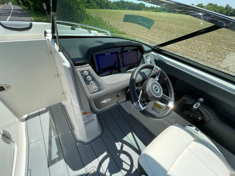 Slide: The Image of 2024 Chaparral 250 OSX boat interior with captain's chair and dashboard. - 18