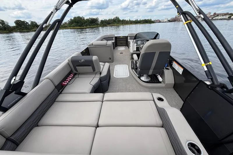 Slide: The Image of 2023 Barletta Corsa 25U pontoon boat interior with luxurious seating on a calm lake. - 13
