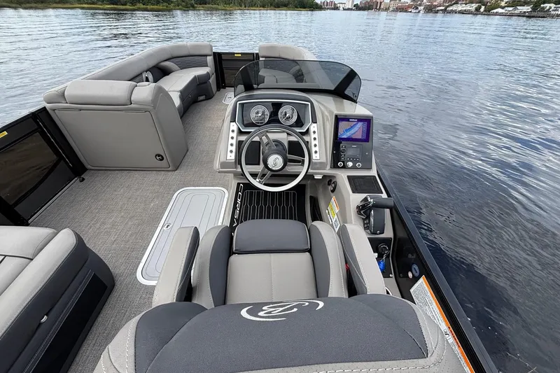 Slide: The Image of 2023 Barletta Corsa 25U boat interior with modern dashboard and seating on water. - 8
