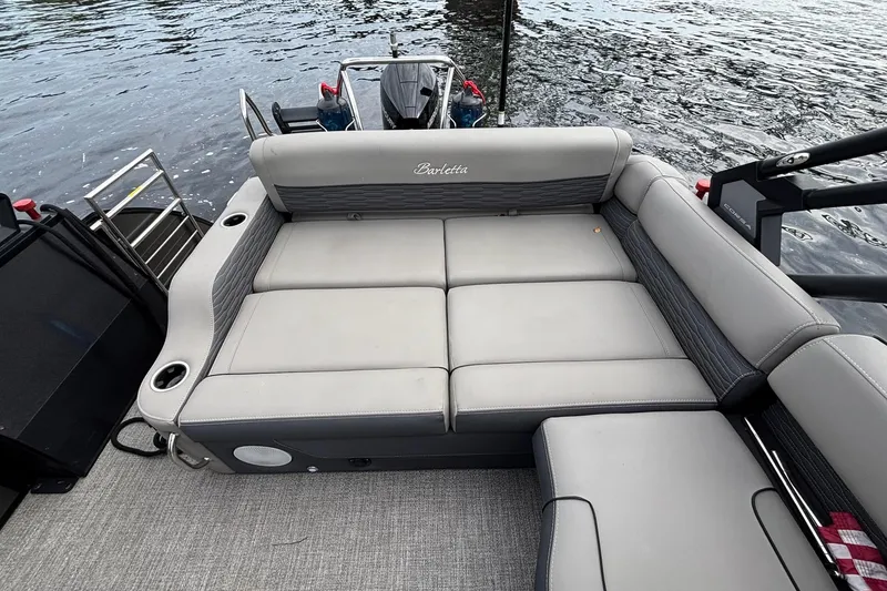 Slide: The Image of 2023 Barletta Corsa 25U pontoon boat with spacious seating on a calm lake. - 9