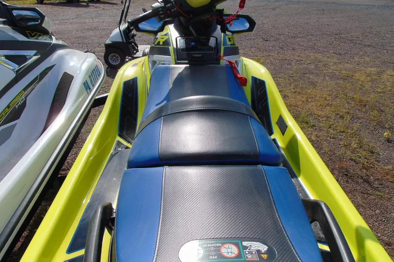 Slide: The Image of 2020 Yamaha WaveRunner GP1800R SVHO, vibrant yellow and blue design, parked on gravel. - 7