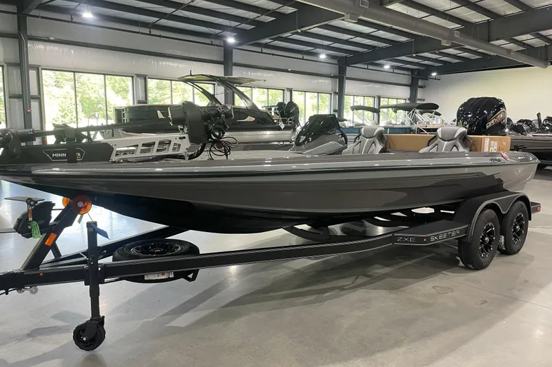 The Image of 2026 Skeeter ZXE20 boat in showroom, sleek design, dual-axle trailer. - 0