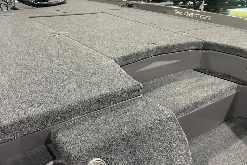 Slide: The Image of 2026 Skeeter ZXE20 boat interior with gray carpeted deck and seating area. - 6