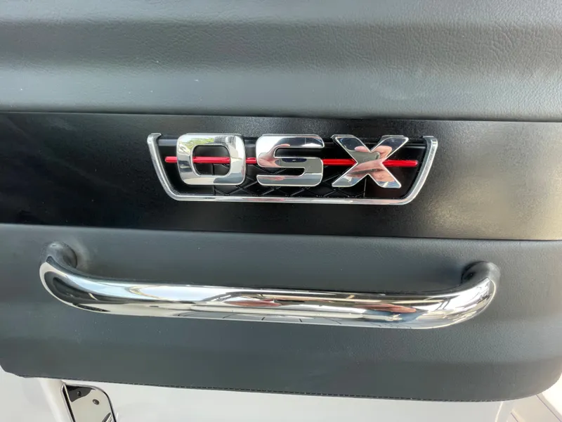 Slide: The Image of 2024 Chaparral 250 OSX logo and chrome handle. - 29