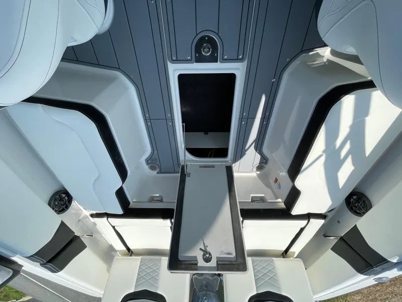 Slide: The Image of 2024 Chaparral 250 OSX boat interior with seating and storage compartments. - 44