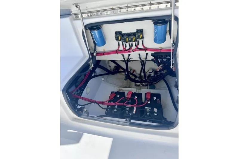 Slide: The Image of Electrical compartment of 2021 Sportsman Heritage 251 Center Console boat, showing wiring and batteries. - 11