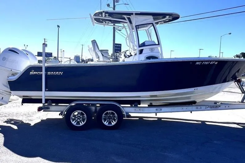 Slide: The Image of 2021 Sportsman Heritage 251 Center Console boat on trailer, side view. - 2