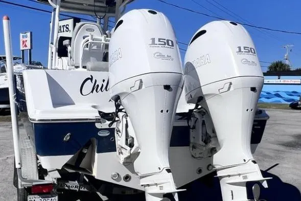 Slide: The Image of 2021 Sportsman Heritage 251 Center Console with twin Yamaha 150 engines, docked outdoors. - 3