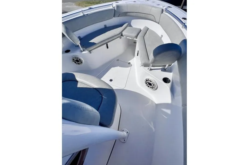 Slide: The Image of 2021 Sportsman Heritage 251 Center Console boat interior with cushioned seating and speakers. - 5