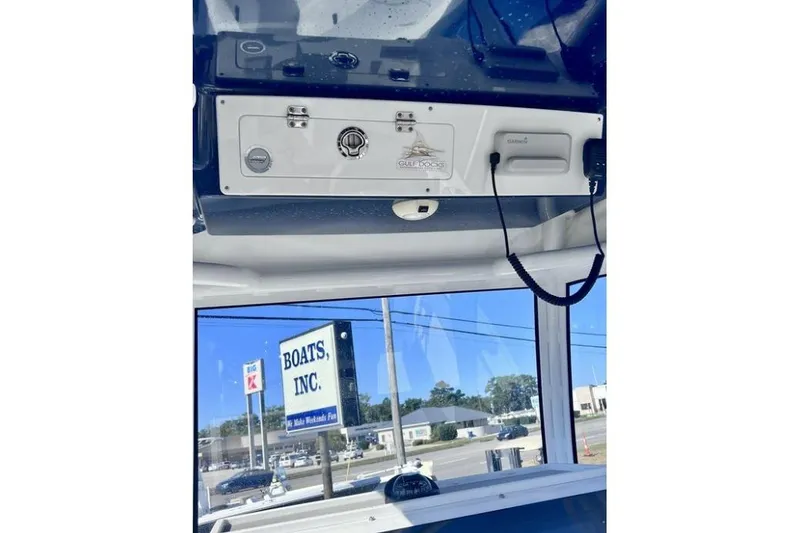 Slide: The Image of 2021 Sportsman Heritage 251 Center Console interior with control panel and exterior view. - 9