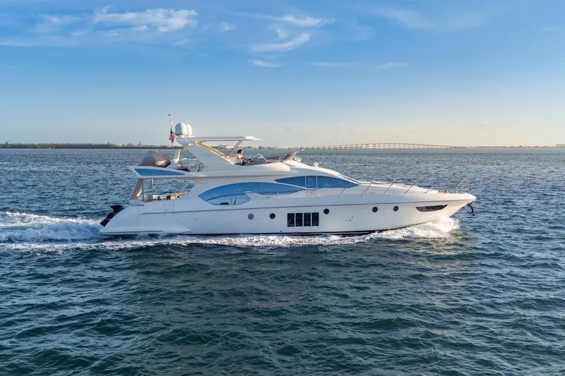 Slide: The Image of 2012 Azimut Evolution yacht cruising on open water under a clear blue sky. - 11