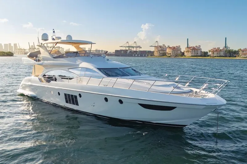 Slide: The Image of Luxurious 2012 Azimut Evolution yacht cruising in a scenic harbor setting. - 12