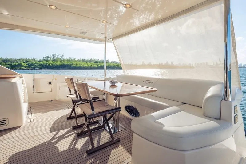 Slide: The Image of Luxurious 2012 Azimut Evolution yacht deck with seating and scenic water view. - 28
