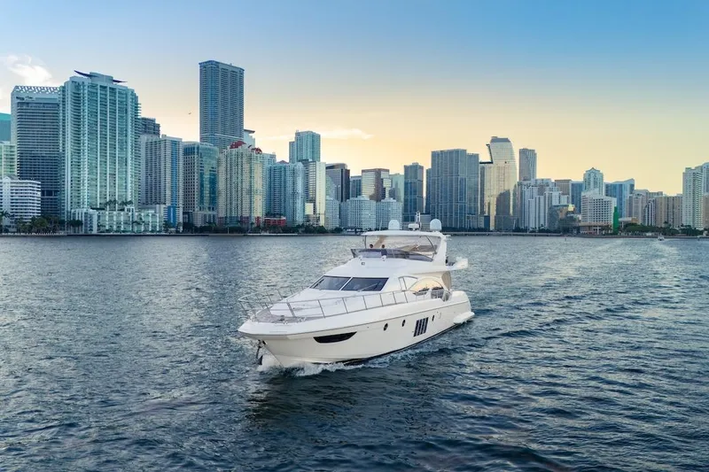 Slide: The Image of Luxury 2012 Azimut Evolution yacht cruising near city skyline at sunset. - 3