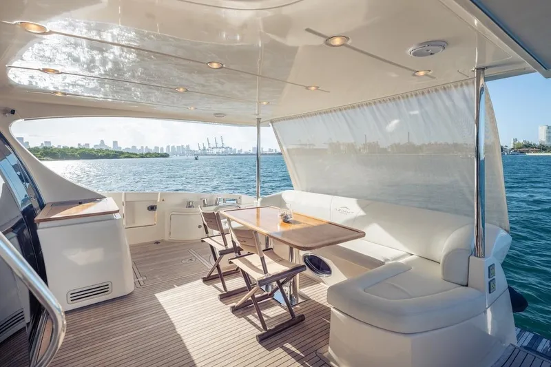 Slide: The Image of Luxurious 2012 Azimut Evolution yacht deck with seating, table, and ocean view. - 31