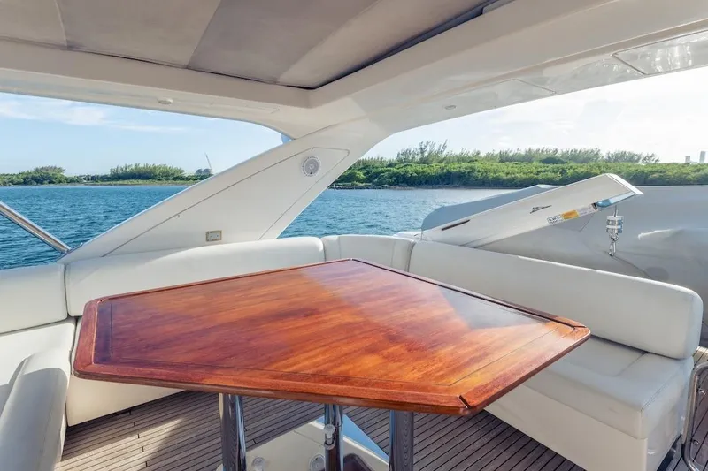 Slide: The Image of Luxurious 2012 Azimut Evolution yacht interior with wooden table and scenic ocean view. - 36