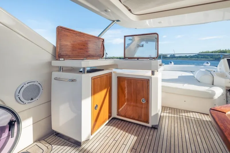Slide: The Image of Luxurious 2012 Azimut Evolution yacht interior with wooden cabinetry and scenic water view. - 40