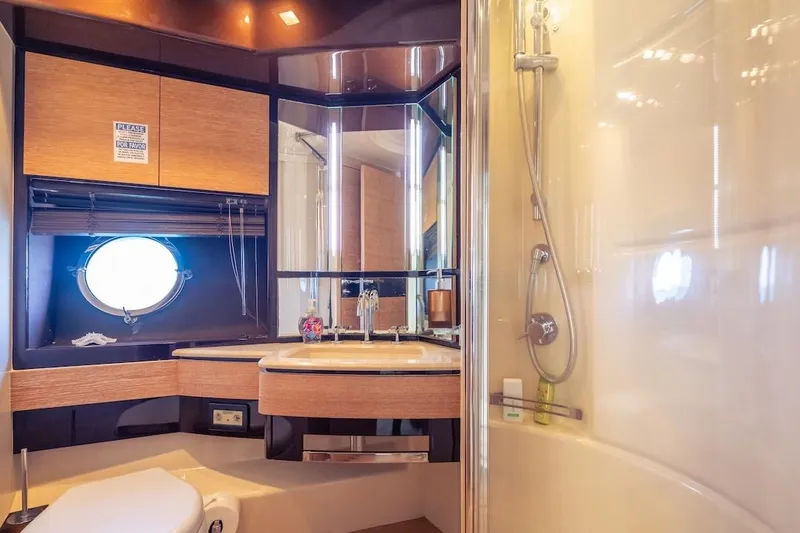 Slide: The Image of Luxurious 2012 Azimut Evolution yacht bathroom with modern fixtures and porthole window. - 46