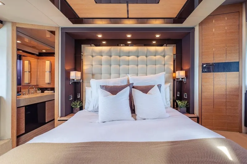 Slide: The Image of Luxurious bedroom interior on 2012 Azimut Evolution yacht, featuring elegant decor and plush bedding. - 49