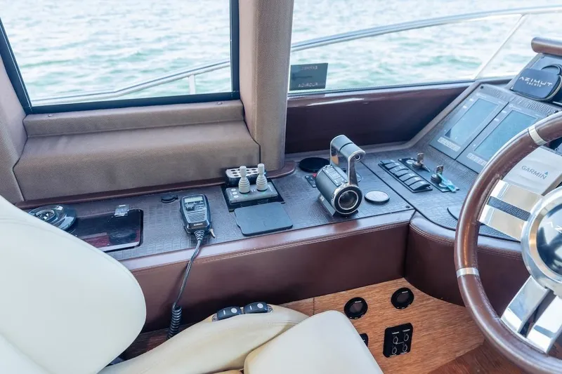 Slide: The Image of Helm of 2012 Azimut Evolution yacht with navigation controls and steering wheel. - 62