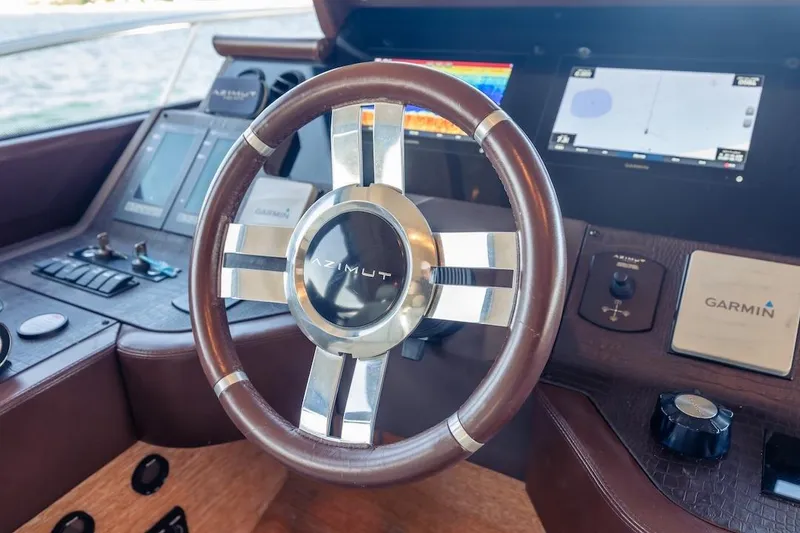 Slide: The Image of Steering wheel of 2012 Azimut Evolution yacht with Garmin navigation system. - 63