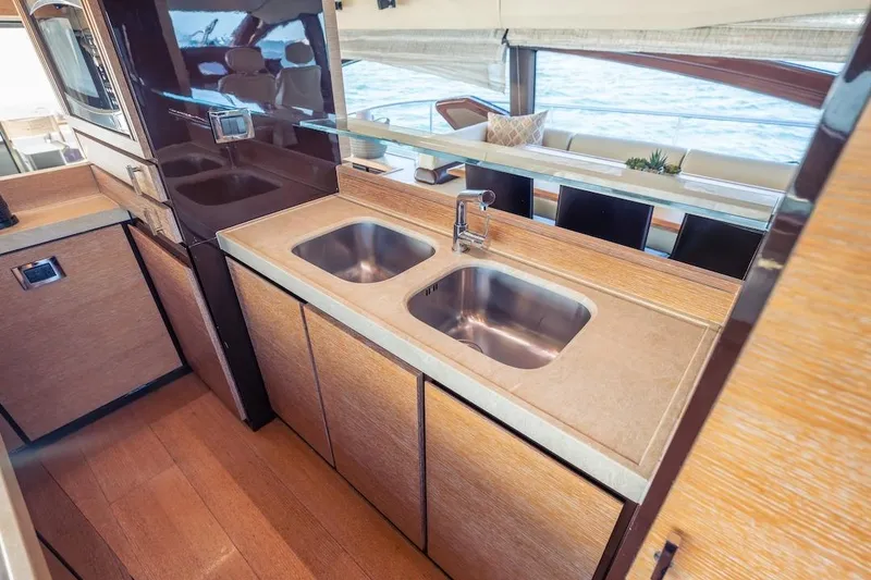 Slide: The Image of Luxurious 2012 Azimut Evolution yacht kitchen with dual sinks and modern design. - 66