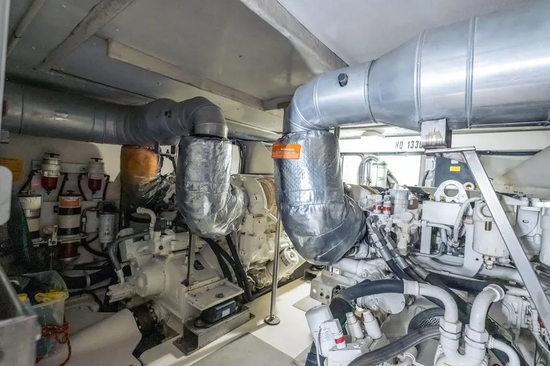 Slide: The Image of Engine room of 2012 Azimut Evolution yacht, featuring complex machinery and ventilation systems. - 70