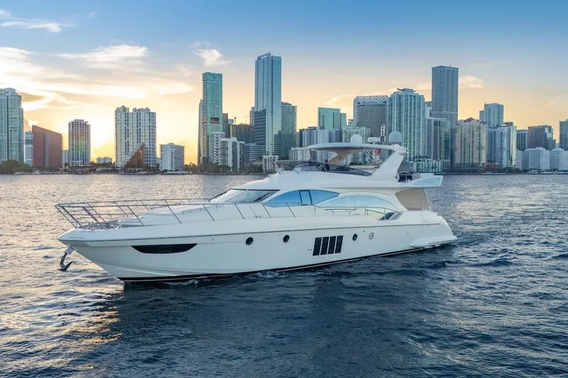 Slide: The Image of Luxurious 2012 Azimut Evolution yacht cruising near a city skyline at sunset. - 8