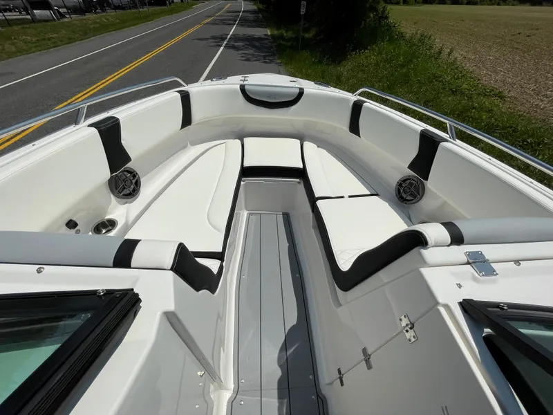 Slide: The Image of 2024 Chaparral 250 OSX boat interior with white and black seating. - 14
