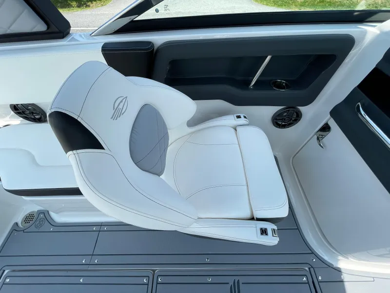 Slide: The Image of 2024 Chaparral 250 OSX boat interior with captain's chair and dashboard. - 25