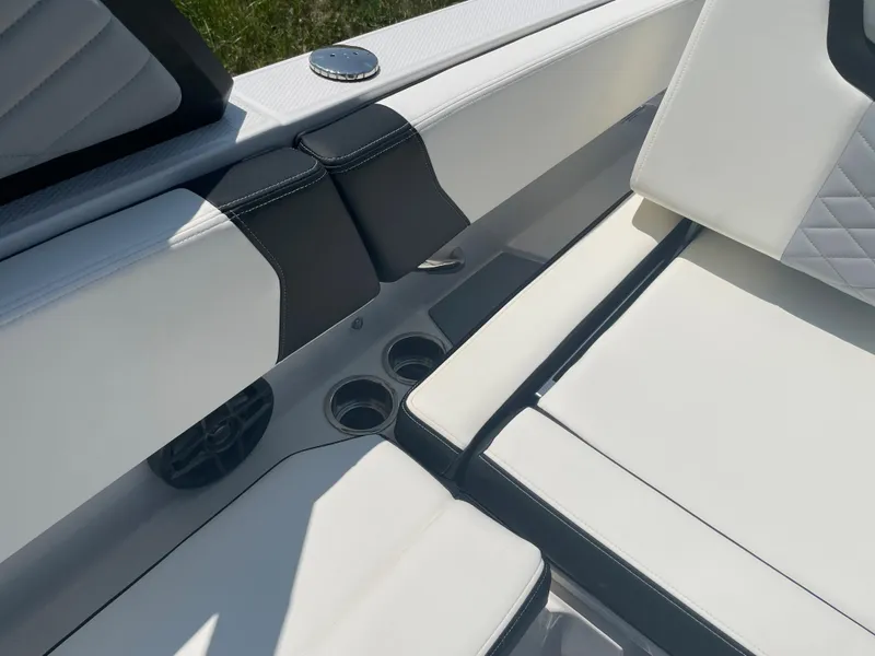 Slide: The Image of 2024 Chaparral 250 OSX boat interior with white and black seating. - 39