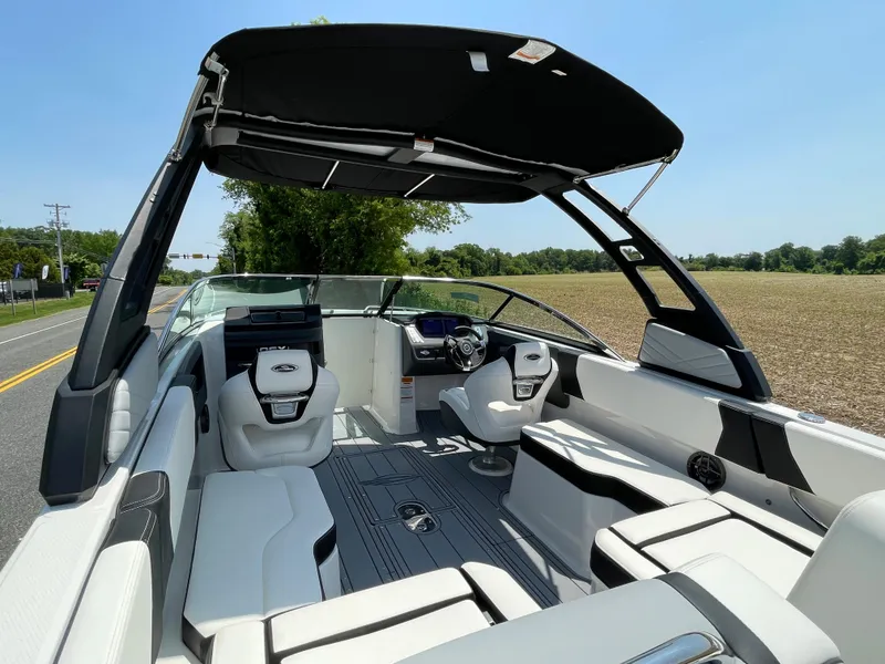 Slide: The Image of 2024 Chaparral 250 OSX boat interior with seating and helm station. - 50