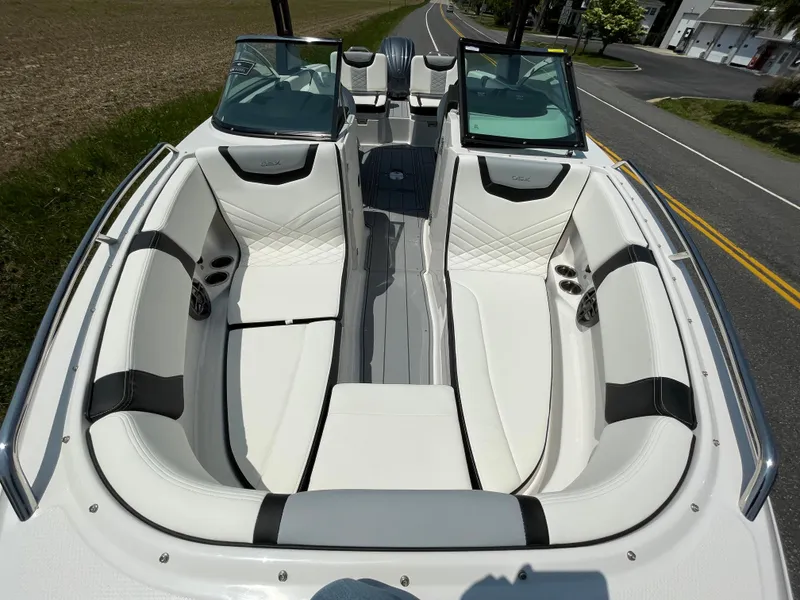 Slide: The Image of 2024 Chaparral 250 OSX boat cleat on textured deck, close-up view. - 8