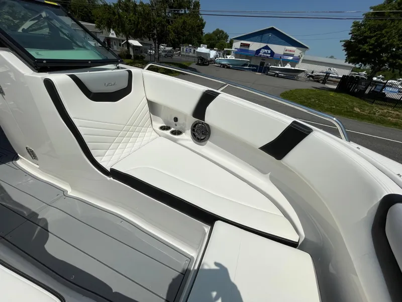 Slide: The Image of 2024 Chaparral 250 OSX boat interior with white and black seating, open bow design. - 9