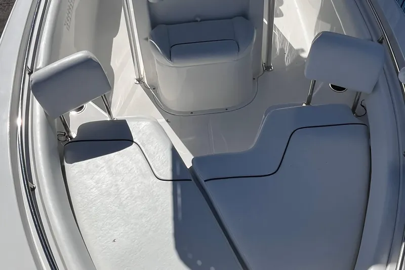 Slide: The Image of 2015 Sea Hunt Ultra 234 boat interior with cushioned seating and stainless steel railings. - 11