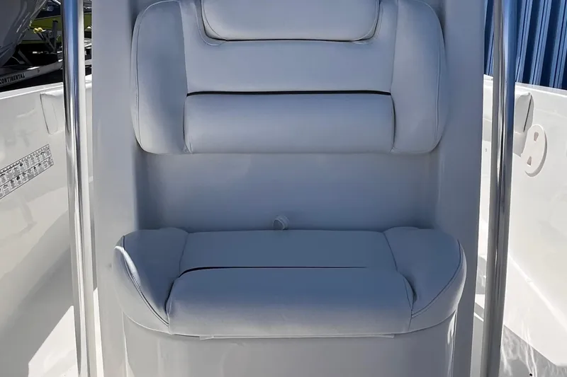 Slide: The Image of 2015 Sea Hunt Ultra 234 boat seat with white cushioned upholstery. - 13