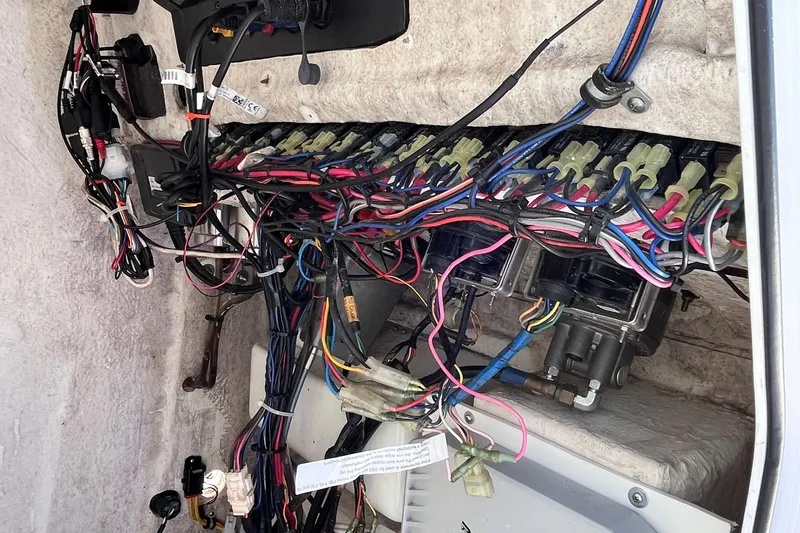 Slide: The Image of Electrical wiring system inside a 2015 Sea Hunt Ultra 234 boat, showcasing complex connections. - 15