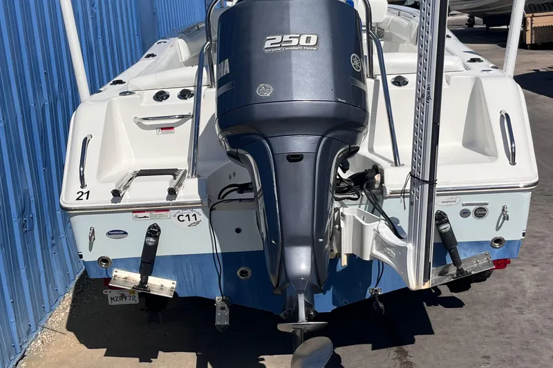 Slide: The Image of 2015 Sea Hunt Ultra 234 boat with Yamaha 250 outboard motor, docked near blue wall. - 18