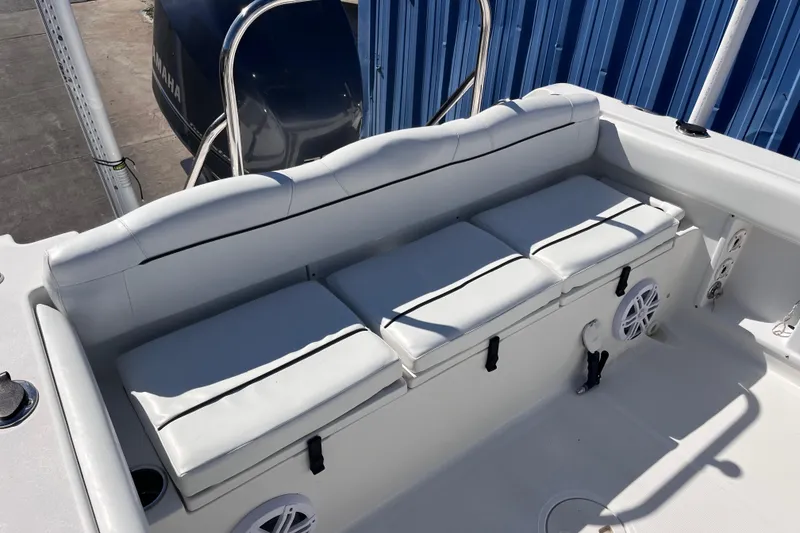 Slide: The Image of 2015 Sea Hunt Ultra 234 boat interior with cushioned seating and Yamaha engine. - 4